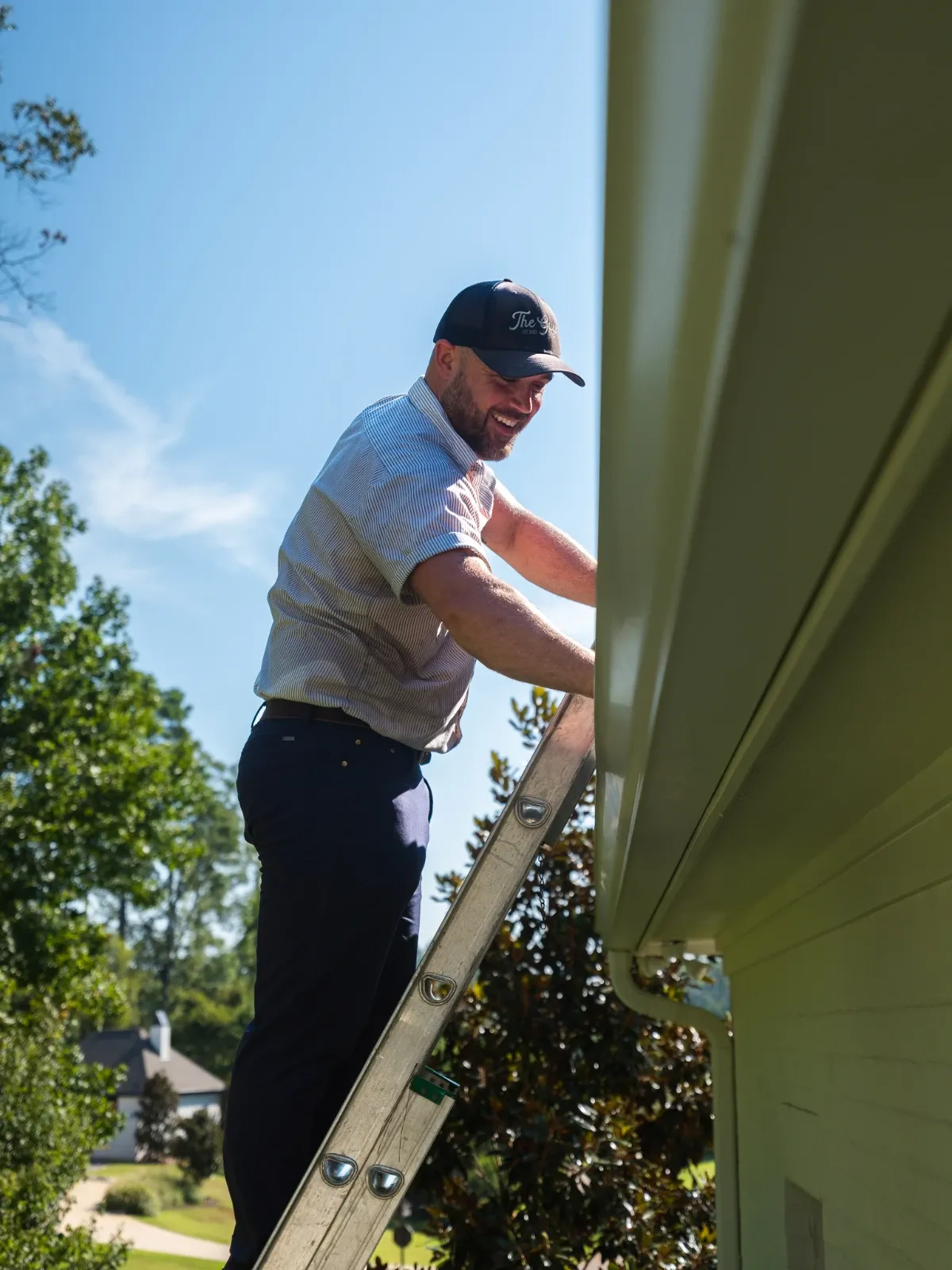Pressure washing technician at work — Exterior Cleaning Guys